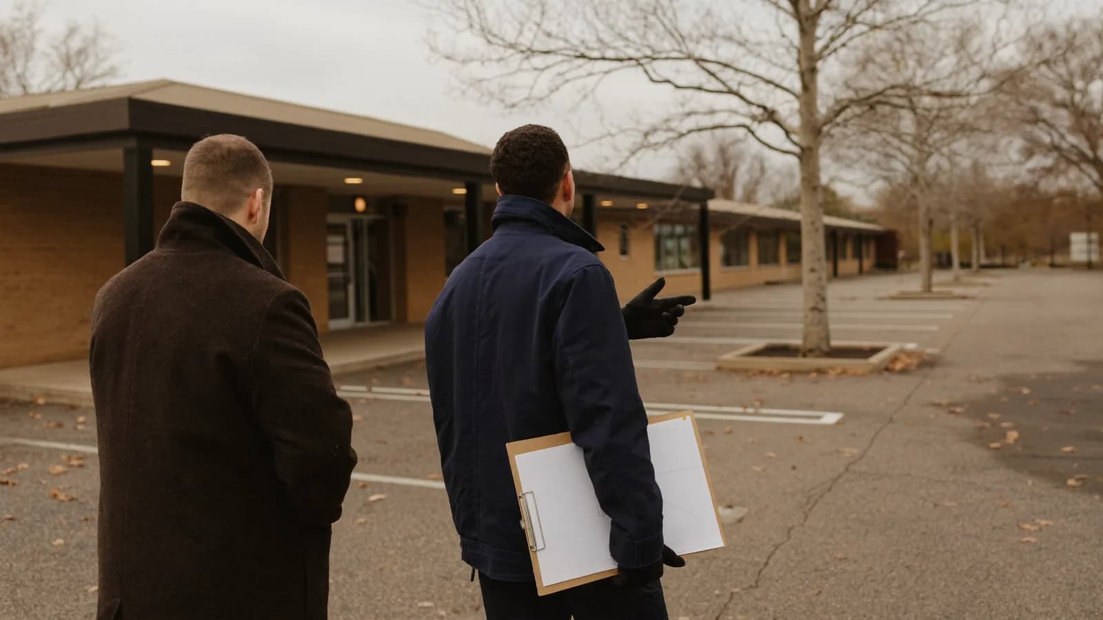 Property manager and contractor walking a commercial lot in fall to plan winter snow service