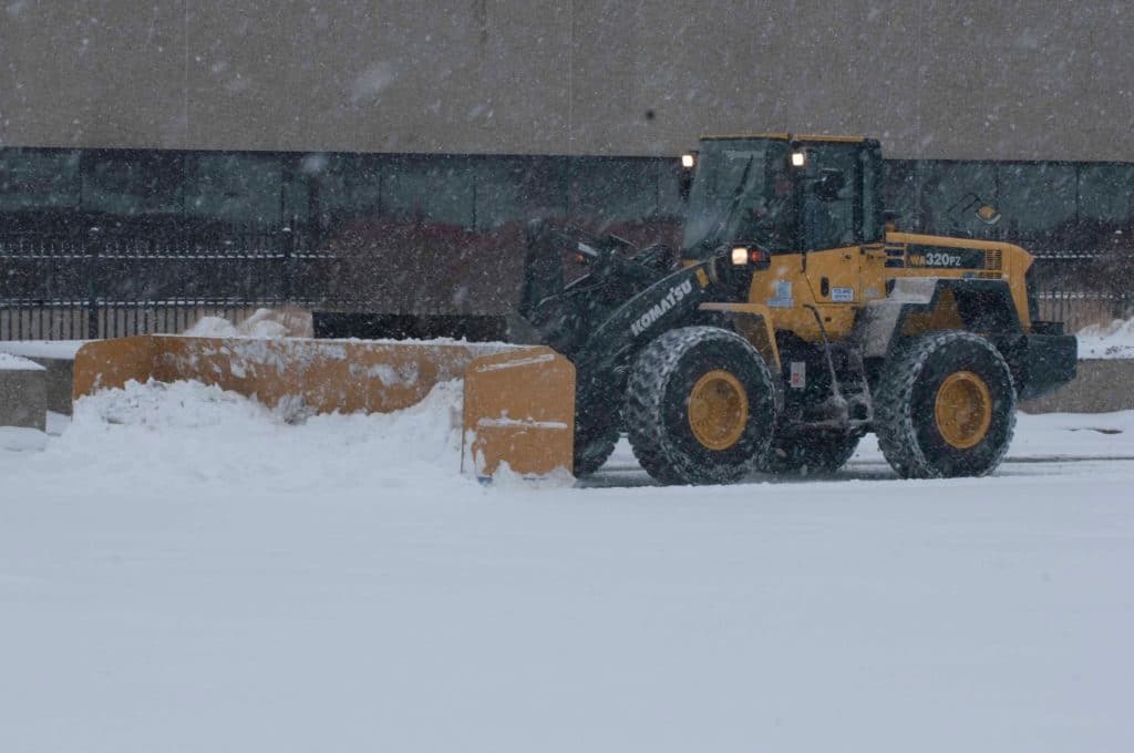 Snow clearing and hauling equipment at work