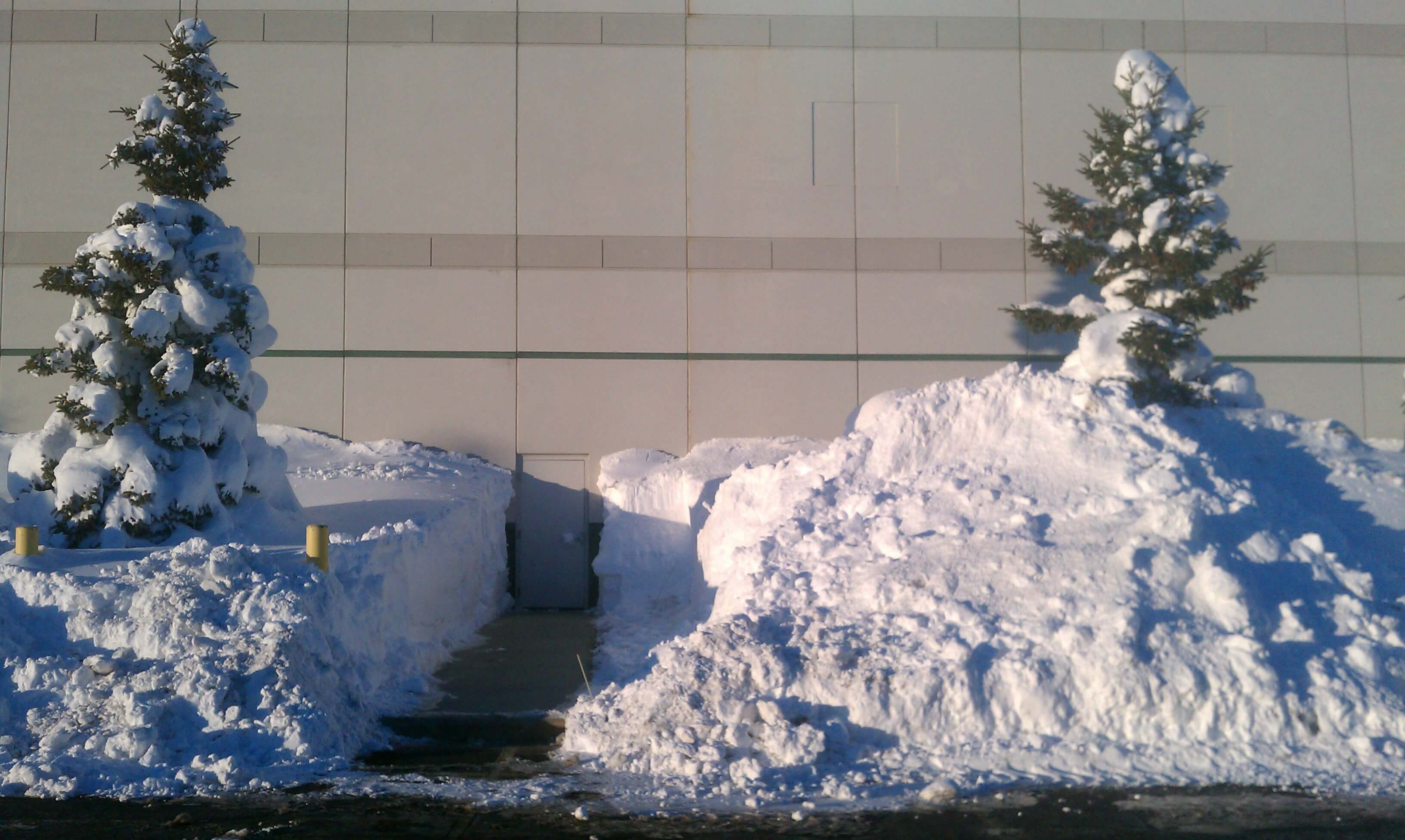 Crew clearing snow from a commercial sidewalk