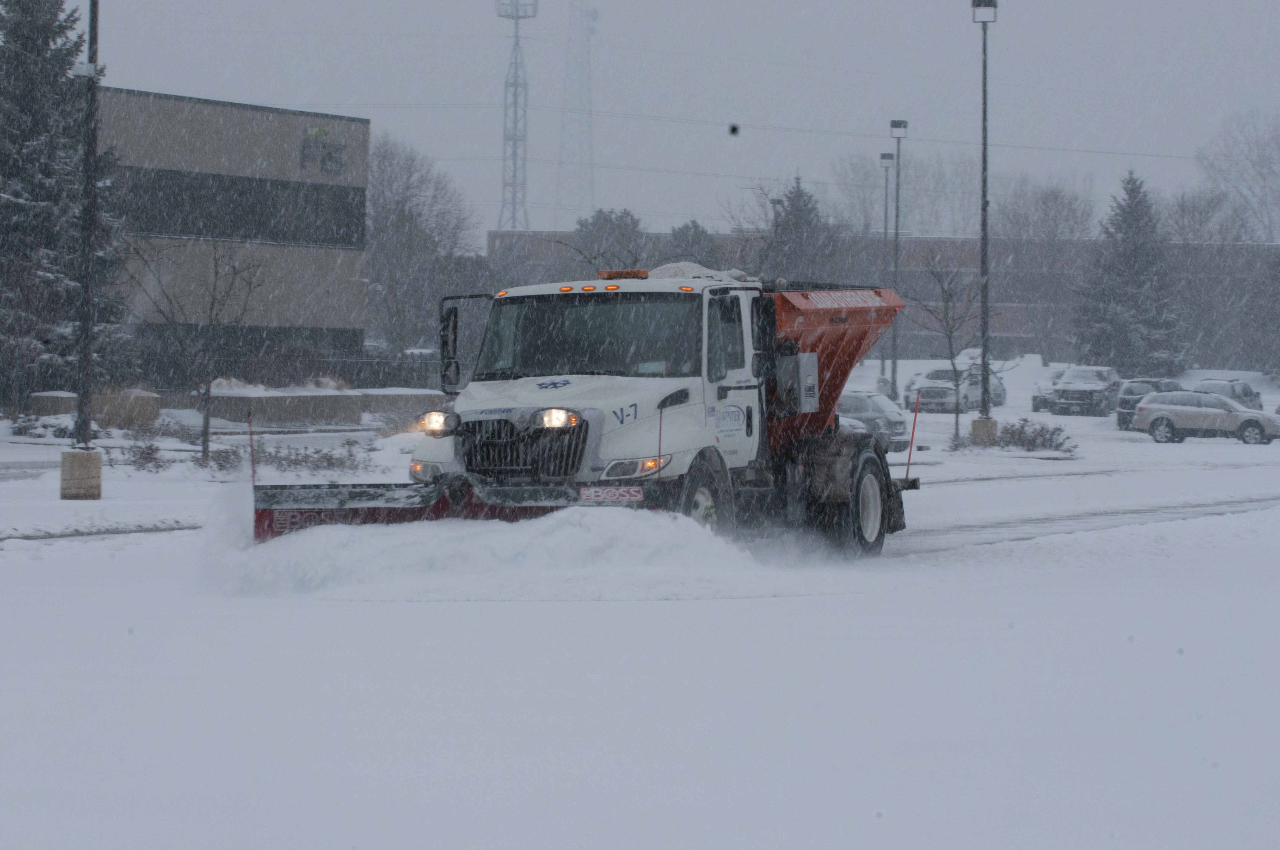 Snowplow clearing snow during a snowstorm