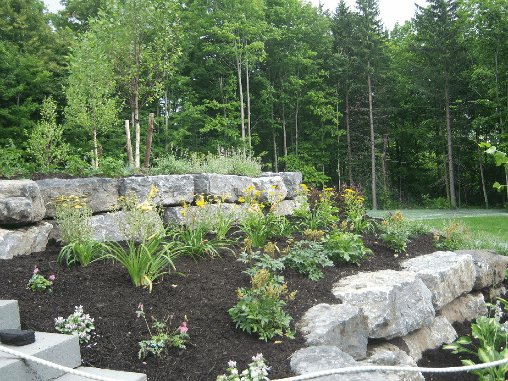 Landscaped stone wall with yellow flowers